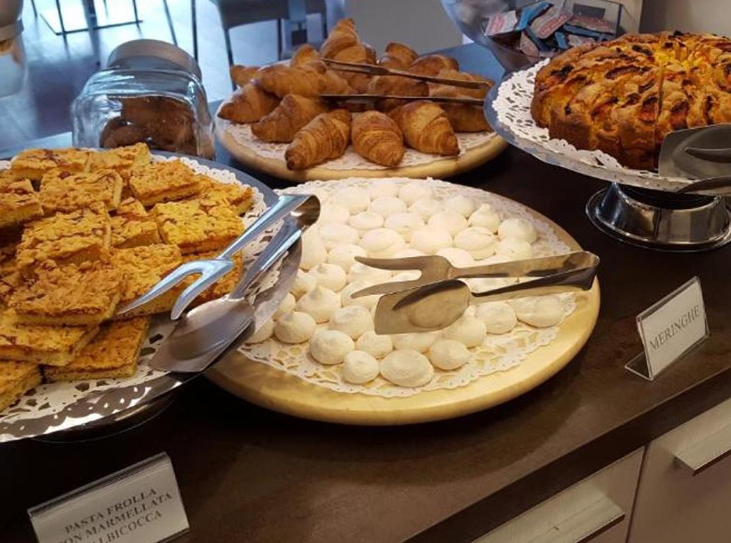 Buffet di dolci: croissant, meringhe, crostata e biscotti, invitanti e deliziosi.